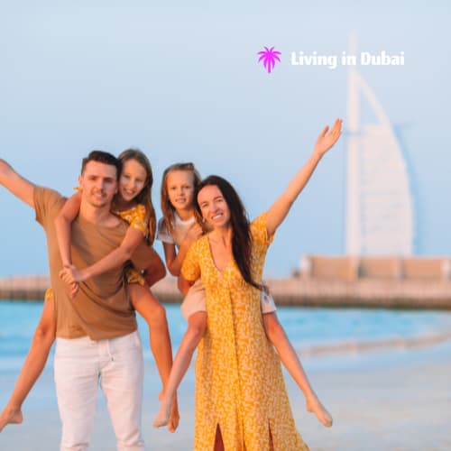 A family laughing and enjoying themselves at the beach in Dubai.